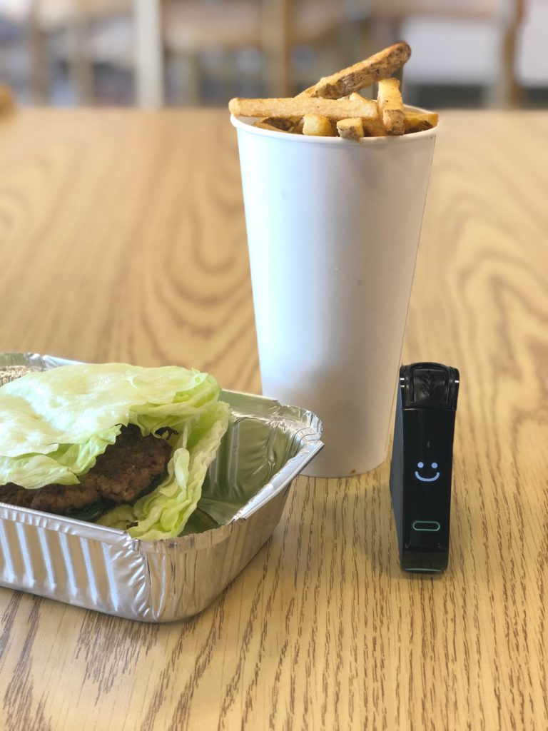 Five Guys Gluten-Free Burger and Fries along with a smiling Nima Sensor