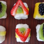 Picture of fruit sushi with strawberries, kiwi and blackberries over rice
