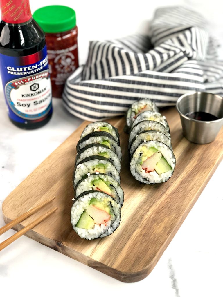 Cut sushi rolls with soy sauce and chili garlic sauce