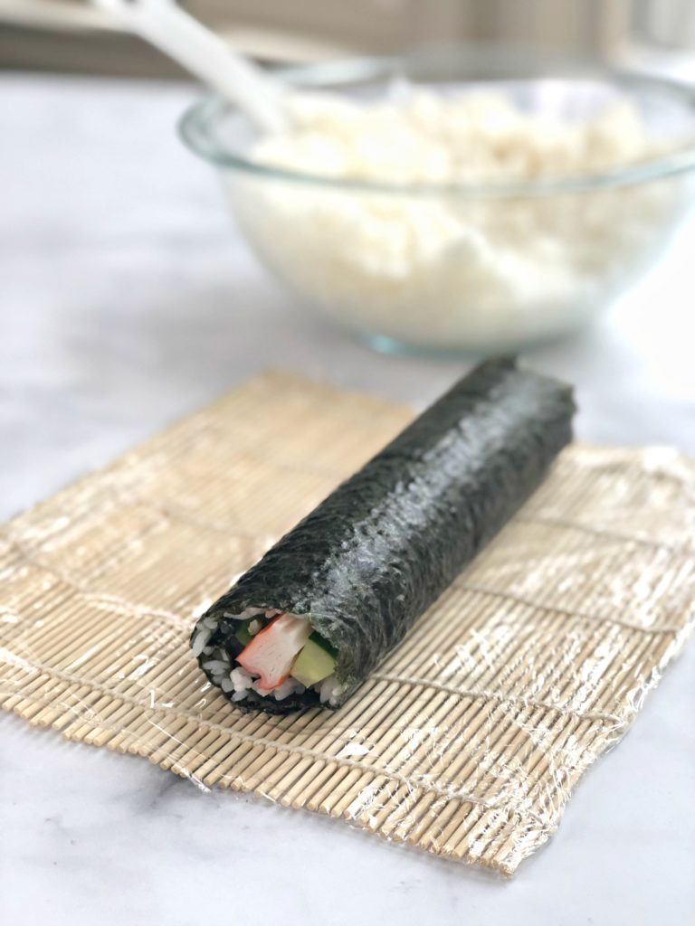 Sushi roll rolled on mat