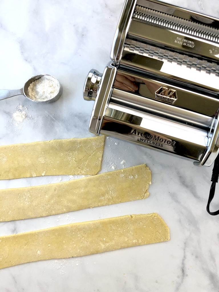 Mercato pasta machine with strips of gluten-free pasta dough