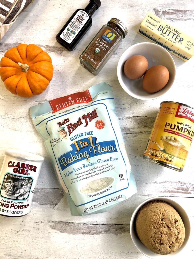 Picture of ingredients needed for pumpkin muffins including flour, eggs, pumpkin puree, vanilla and more