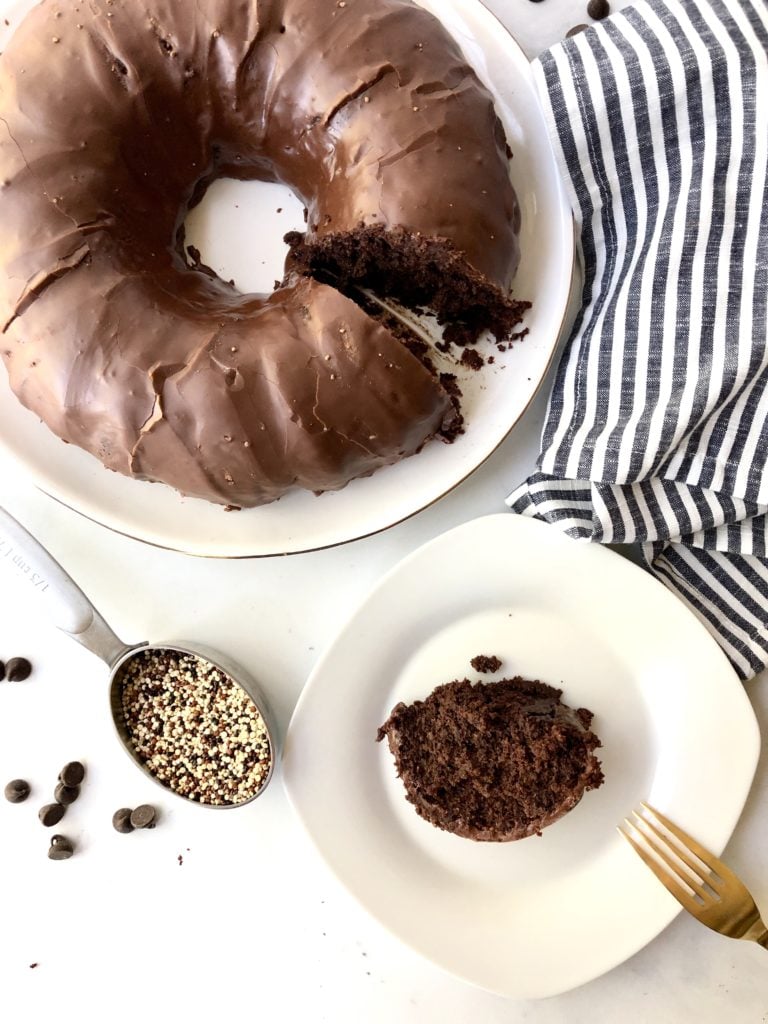 Gluten-Free Chocolate Quinoa cake frosted and plated alongside quinoa