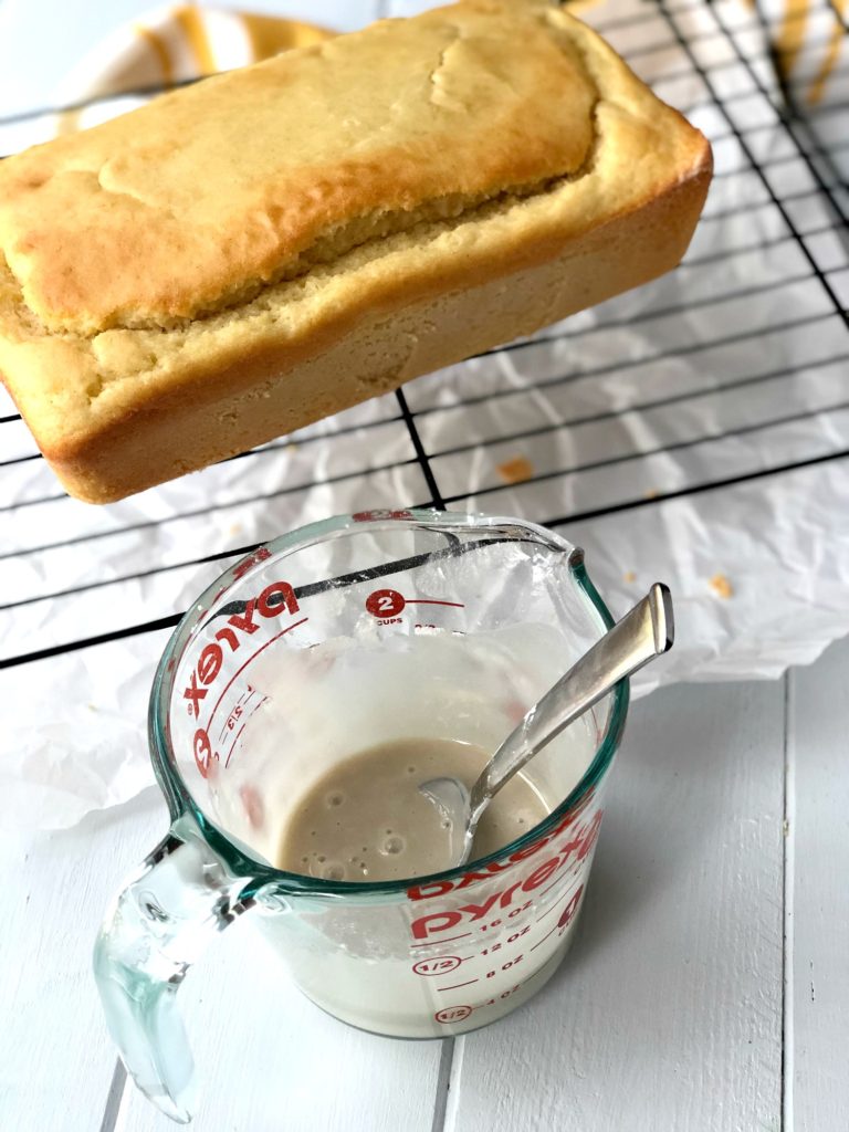 Gluten-Free Lemon Vanilla Pound Cake in background and cashewmilk icing in front