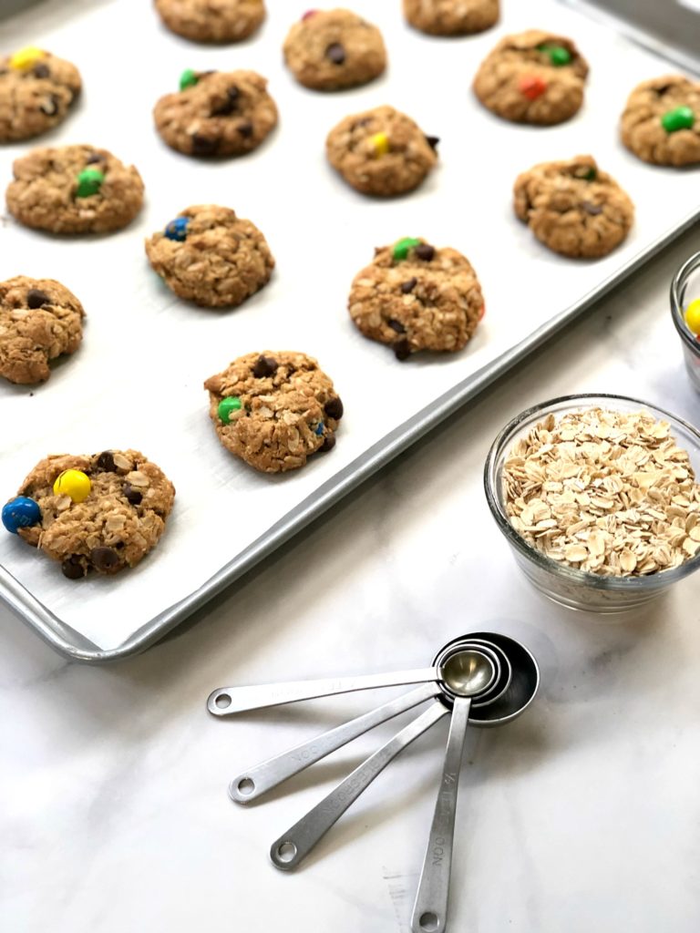 gluten-free monster cookies baked on a cookie sheet