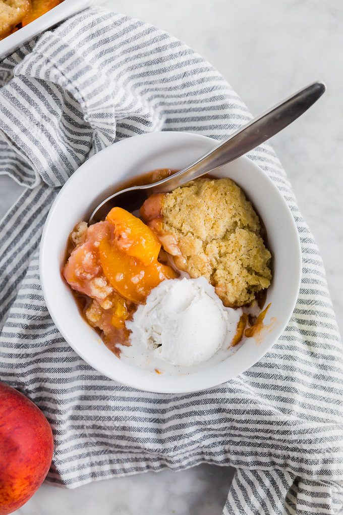 Peach Cobbler in a bowl with ice cream - overhead
