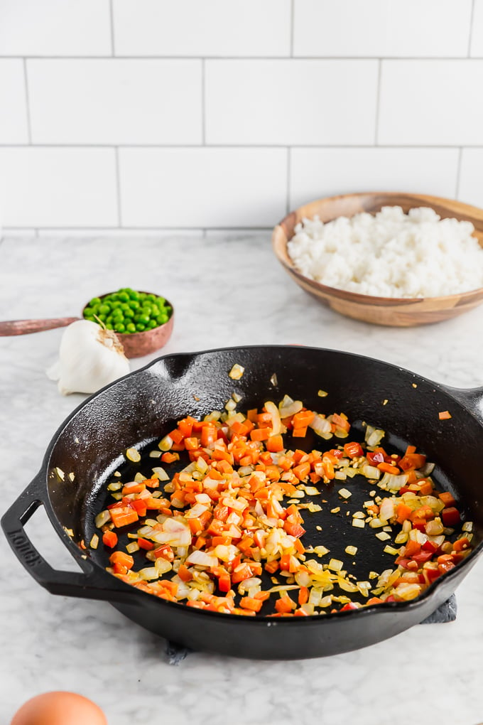 diced carrots and onions sauteing in a pan
