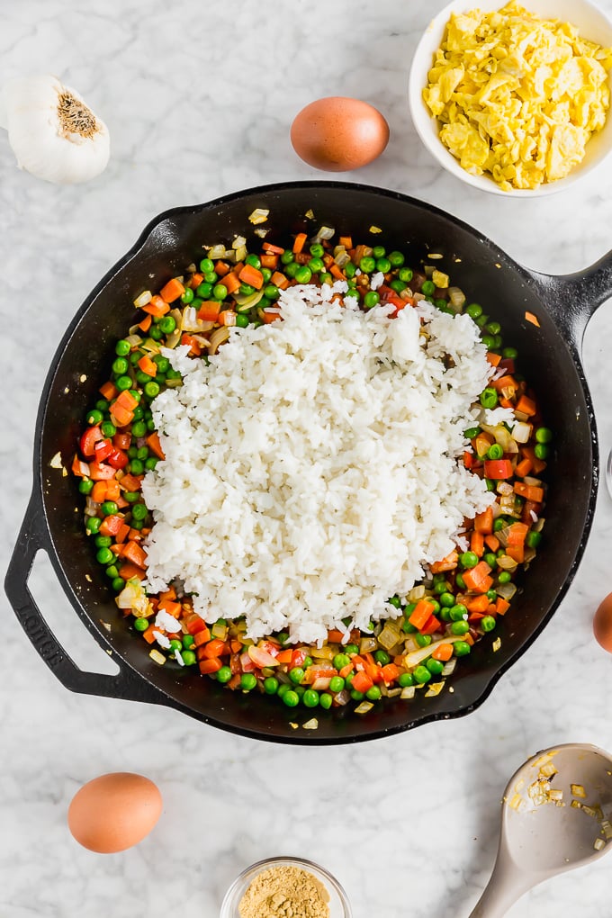 white rice atop cooked vegetables