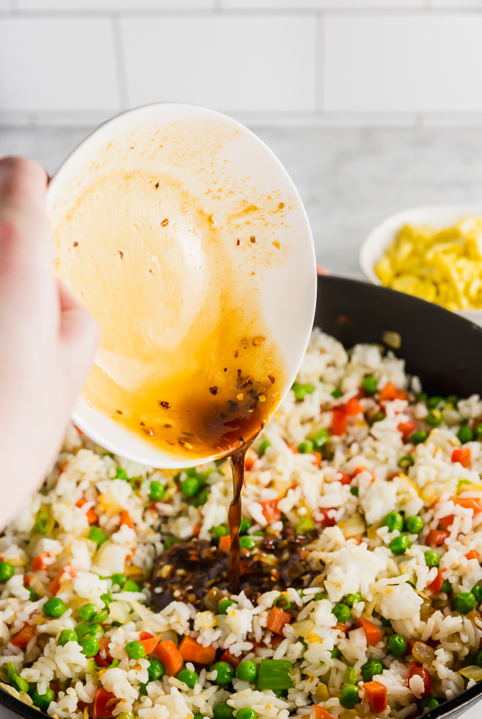 Pouring sauce on egg fried rice