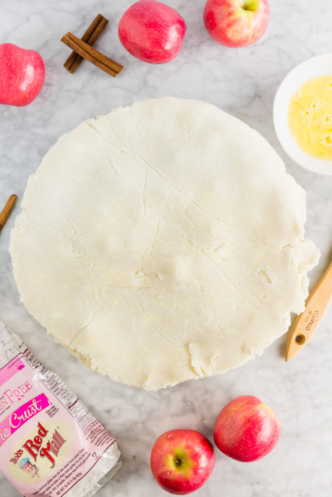 Gluten-free apple pie crust rolled out into disc