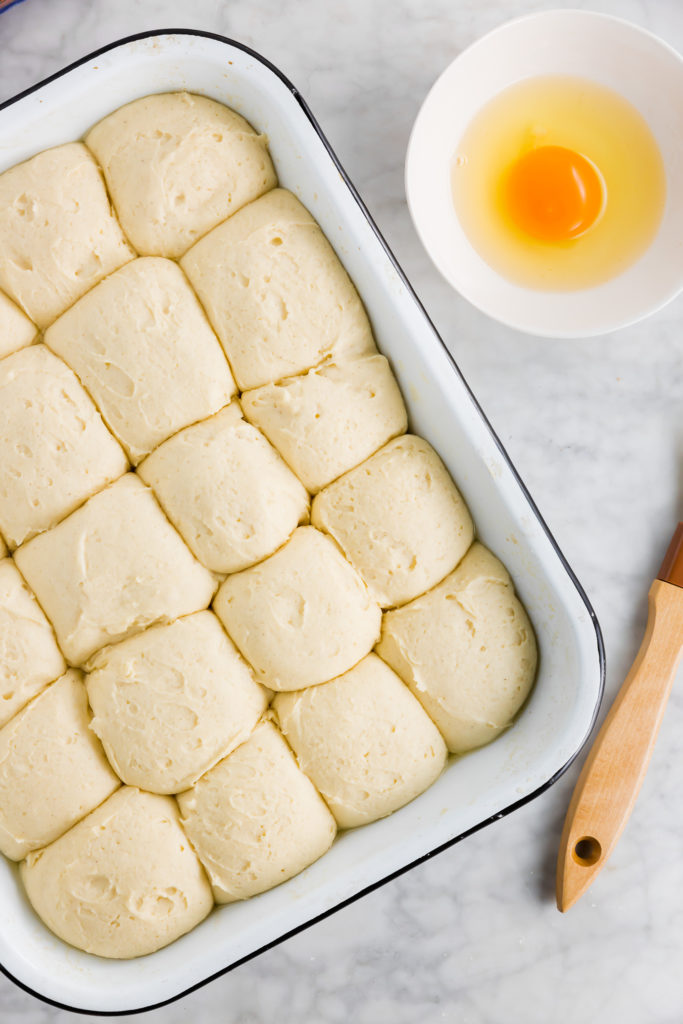 Pull apart gluten-free dinner roll dough with egg wash