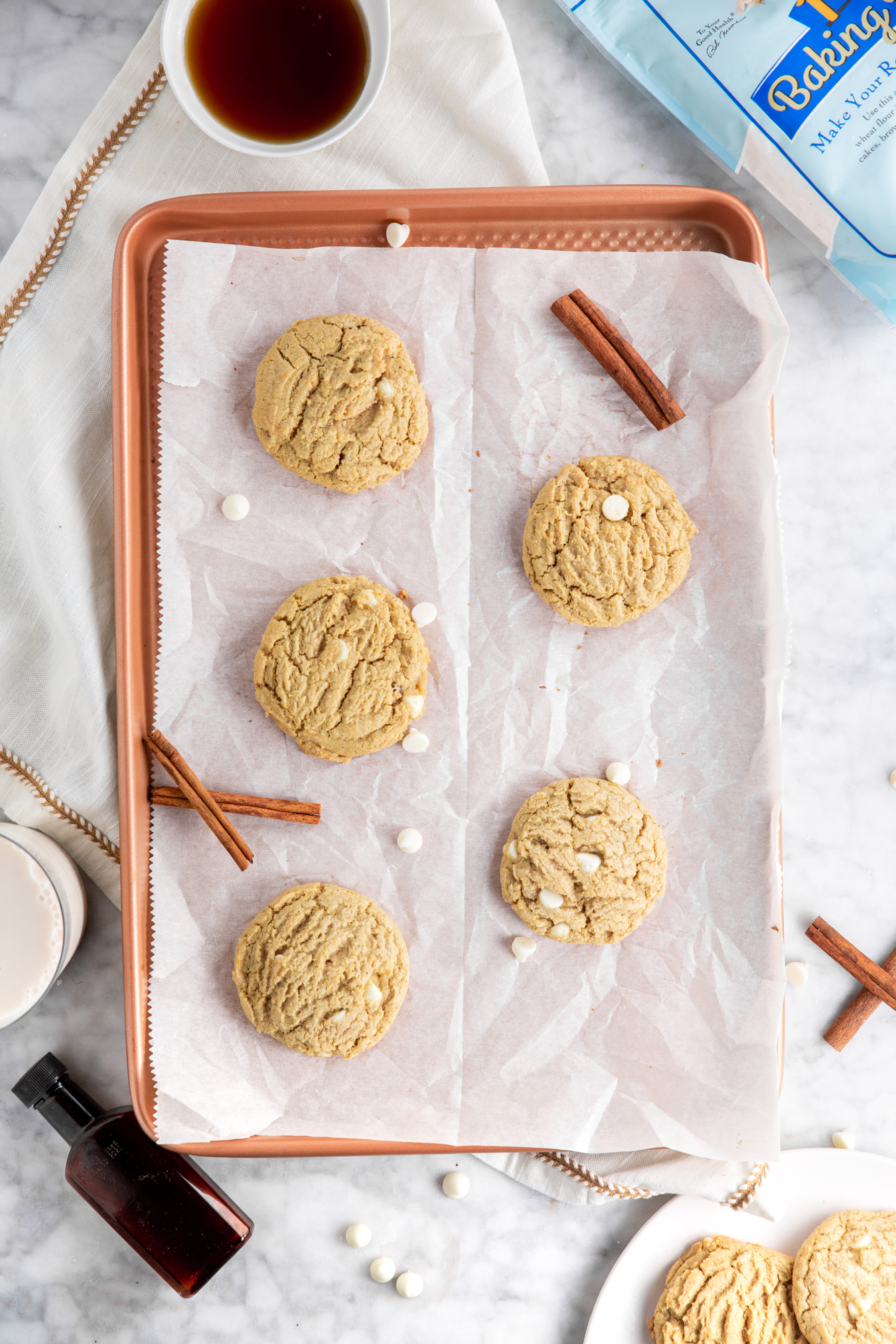 Gluten-Free maple white chocolate cookies baked and fresh out of the oven on a baking sheet