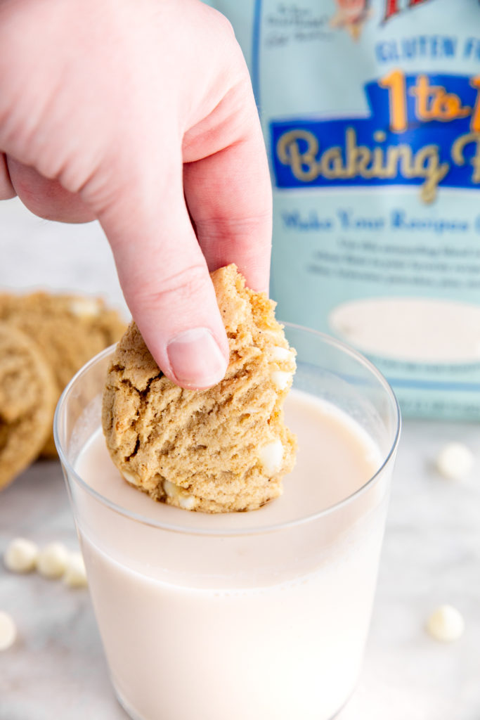 gluten-free maple white chocolate cookies dipped in glass of milk
