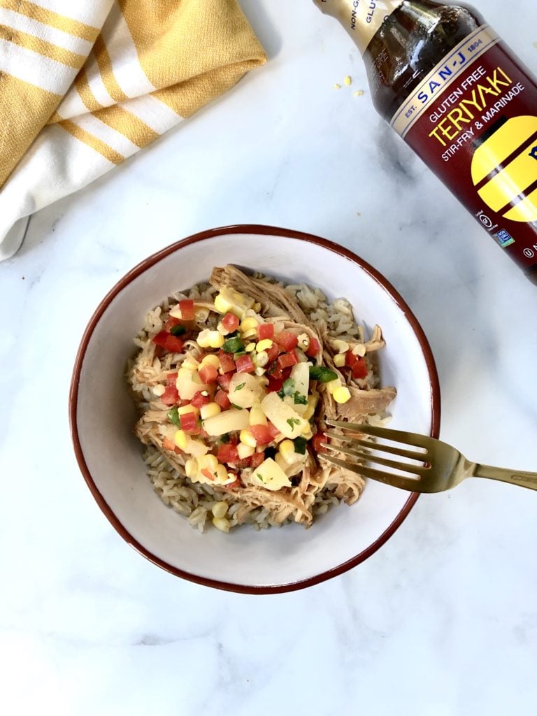 Slow cooker chicken teriyaki chicken bowl topped with pineapple salsa