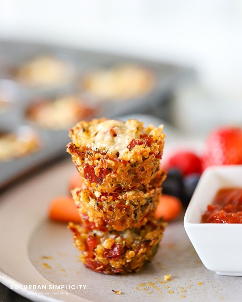 Stack of mini quinoa pizza bites on a plate with marina sauce by Suburan Simplicity
