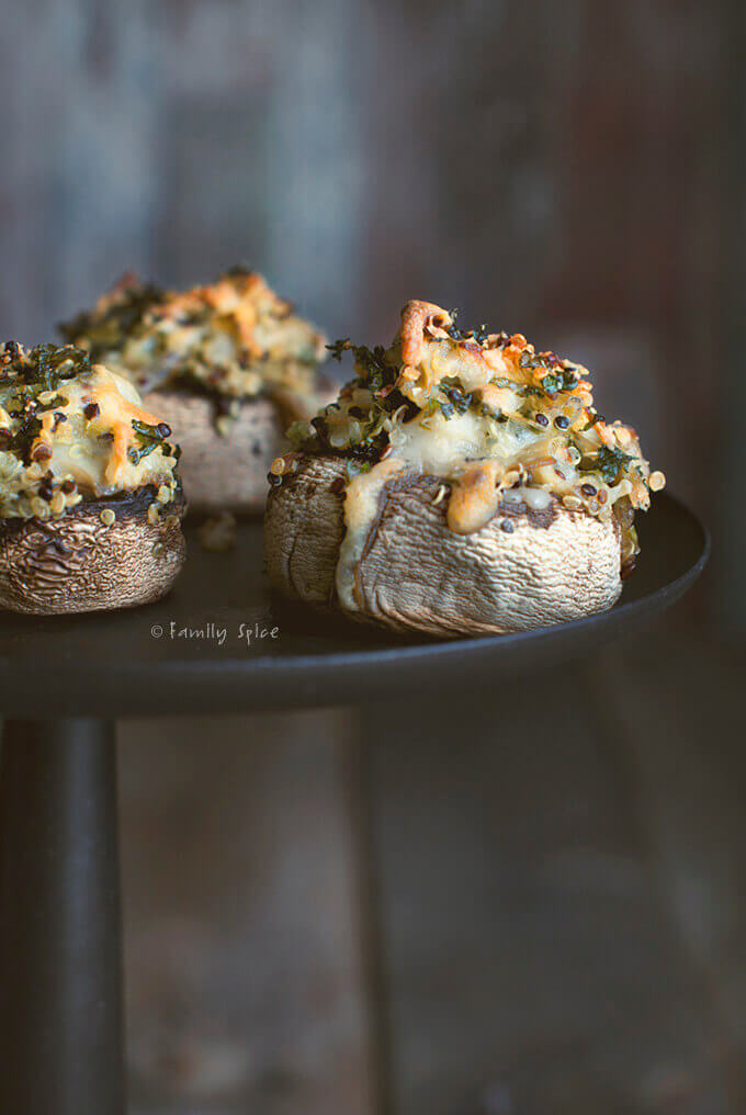 Upclose picture of mushroom stuffed with quinoa and greens and topped with melted cheese
