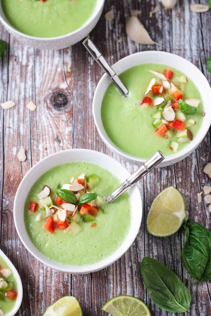 picture of several bowls of cold cucumber soup with tomato garnishes