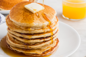 Header image of pancakes doused in maple syrup