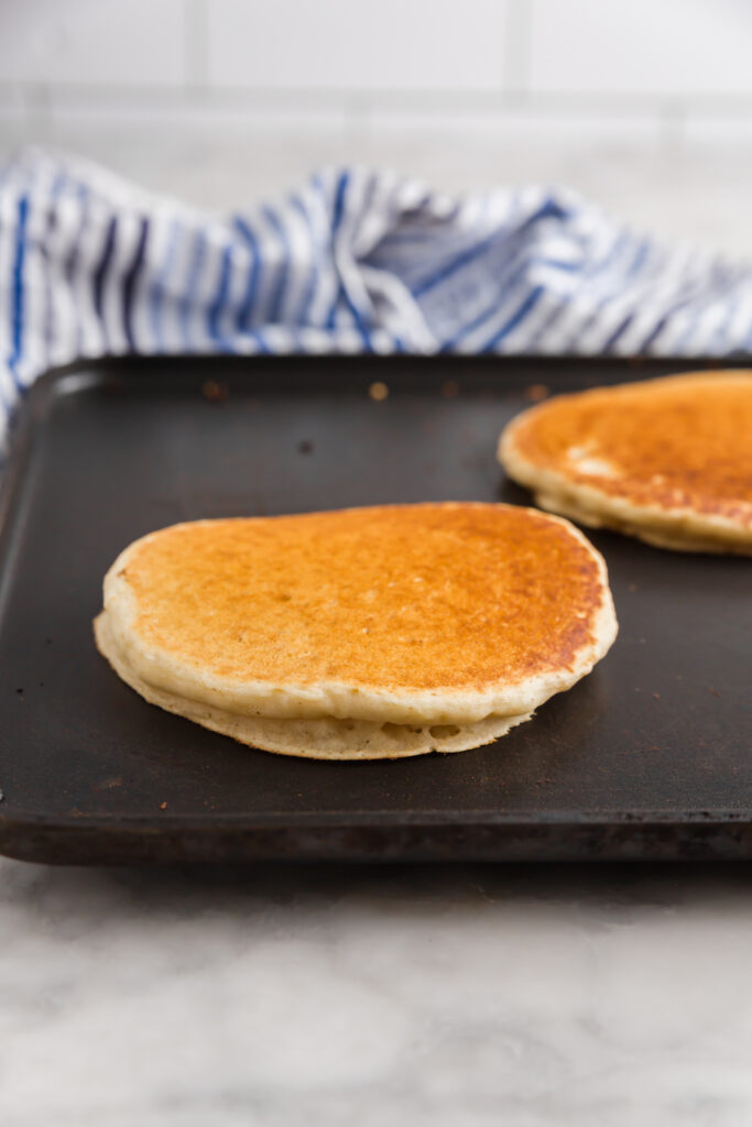 Pancakes cooking on a griddle and becoming fluffy and light