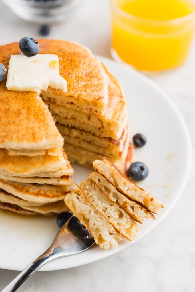 Close up picture of pancakes on a fork and you can see the air bubbles in them