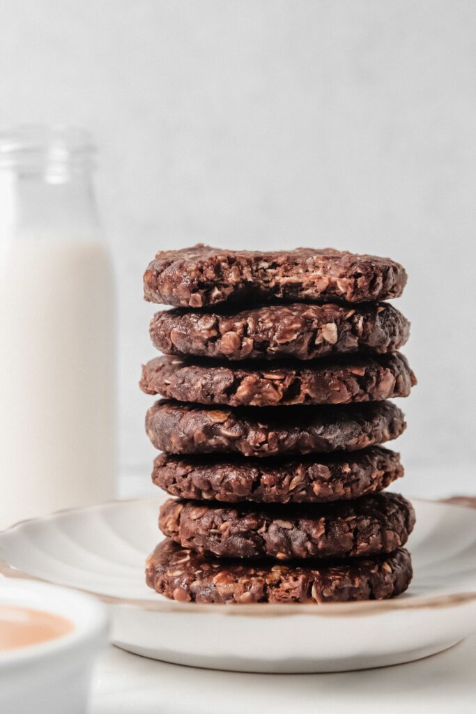 Sack of no-bake gluten-free cookies on a plate with milk in the background