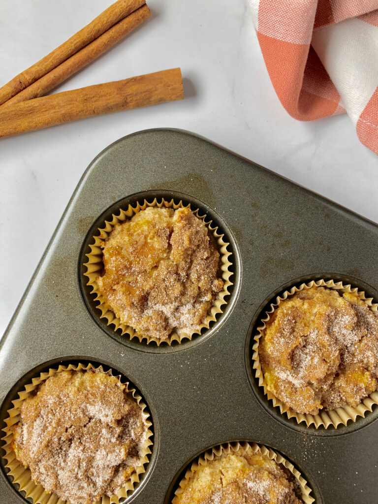 Picture of almond flour muffins right out of the oven and in muffin tin.