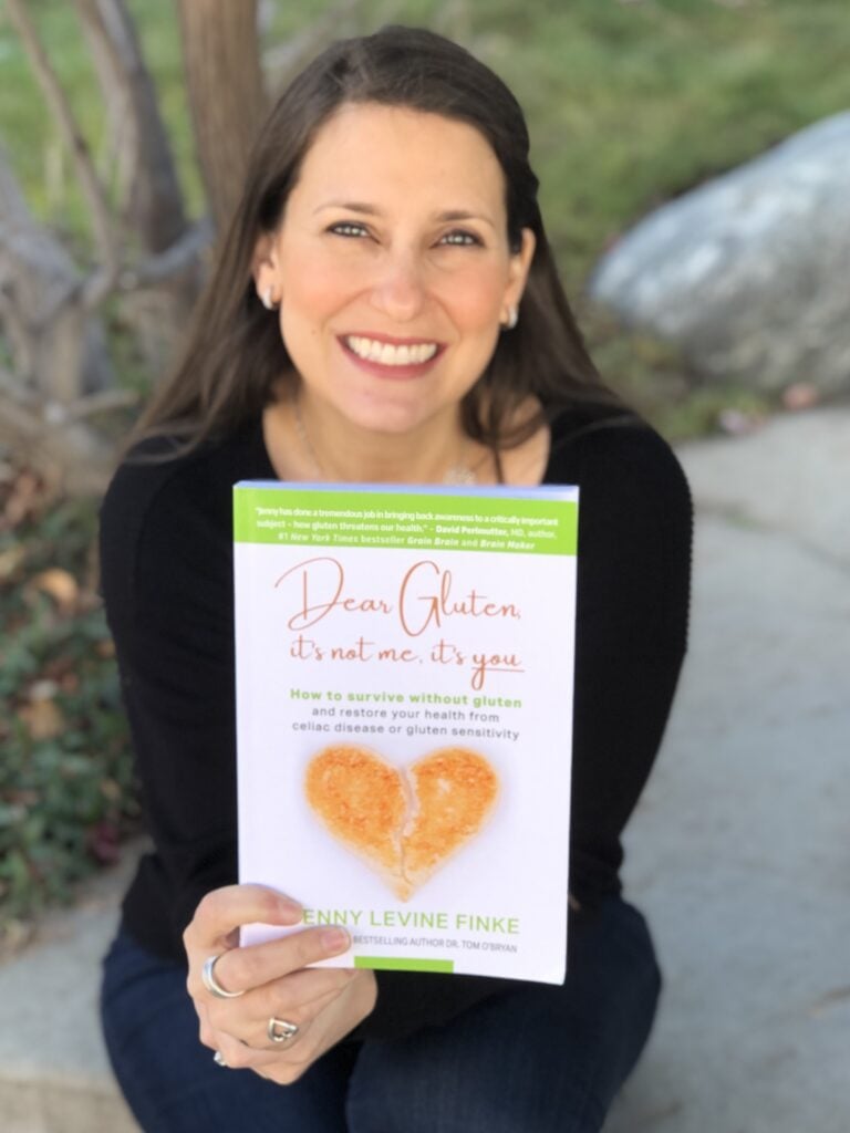 Jenny holding Dear Gluten, It's Not Me, It's You book