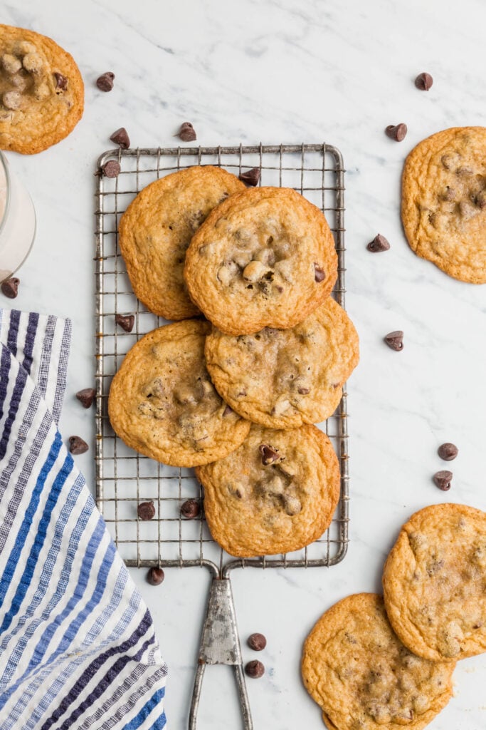 Overhead view of gluten-free chocolate chip cookies on a wire baking rack.