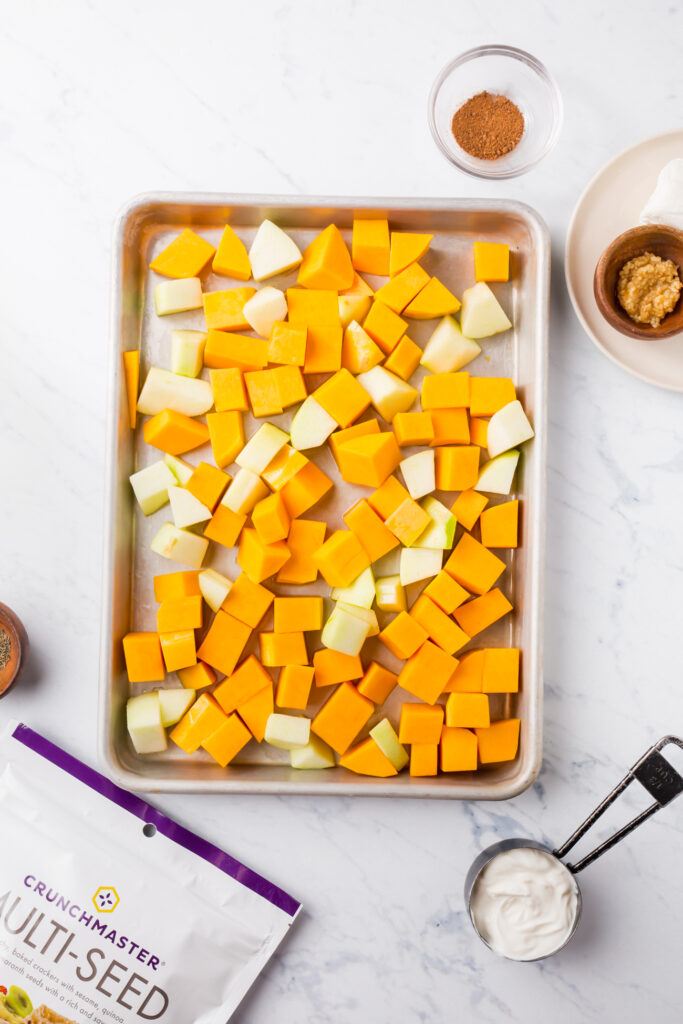 Picture of cubed squash and apples on roasted baking sheet