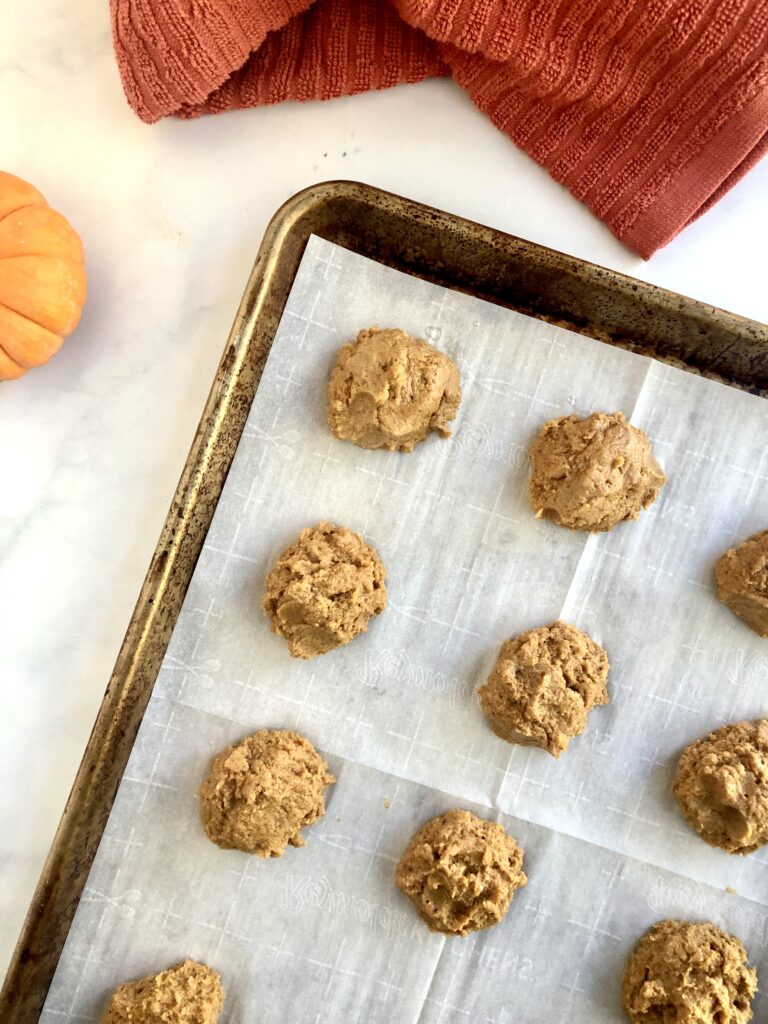 Cookie dough mounds on a baking sheet
