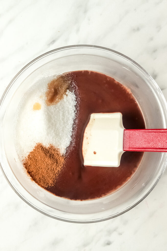 Picture of sugar, vanilla and cinnamon added to the microwaved chocolate pudding
