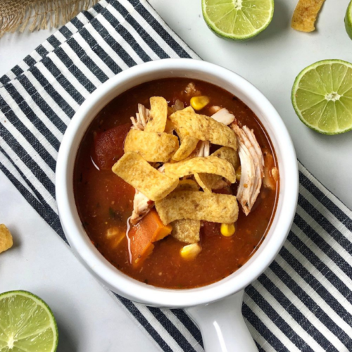 close up of the close up on the chicken enchilada soup in a bowl for header image
