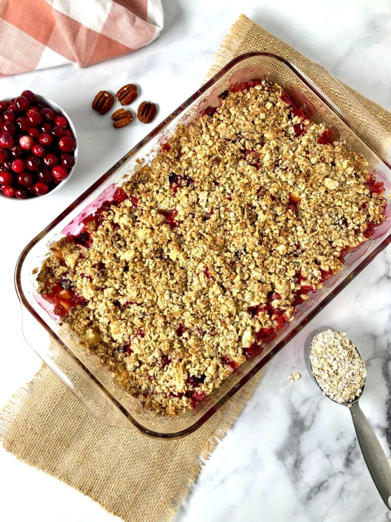 Overhead picture of apple cranberry crisp with cranberries and oats in the picture