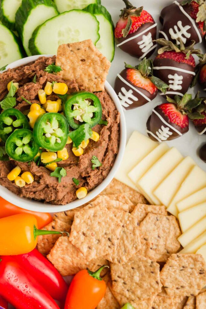 Snack board - up close on bean dip and chocolate footballs.