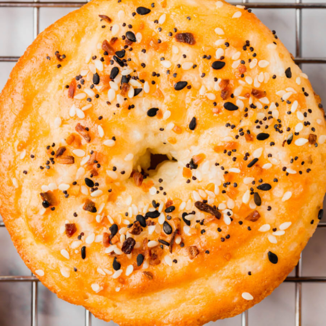 up close on a grain-free bagel made with almond flour and covered with everything bagel seasoning