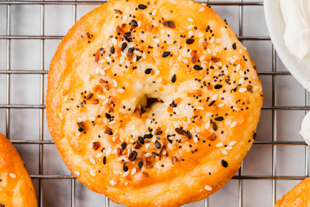up close on a grain-free bagel made with almond flour and covered with everything bagel seasoning