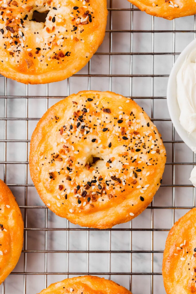 Grain-free bagel with everything bagel topping cooling on wire rack.