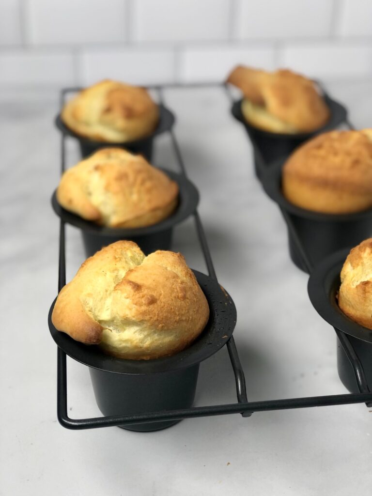 Picture of popovers inside the popover pan. Baked and lightly browned