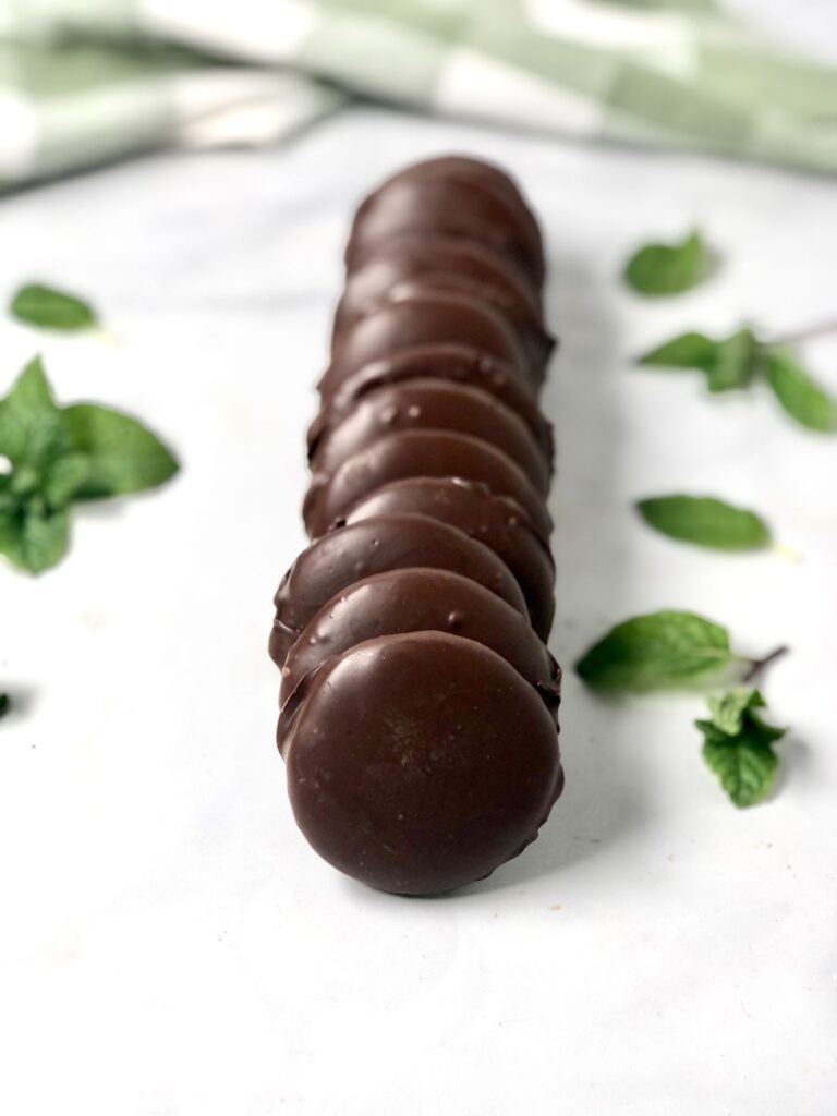 Row of gluten-free thin mint cookies with mint leaves