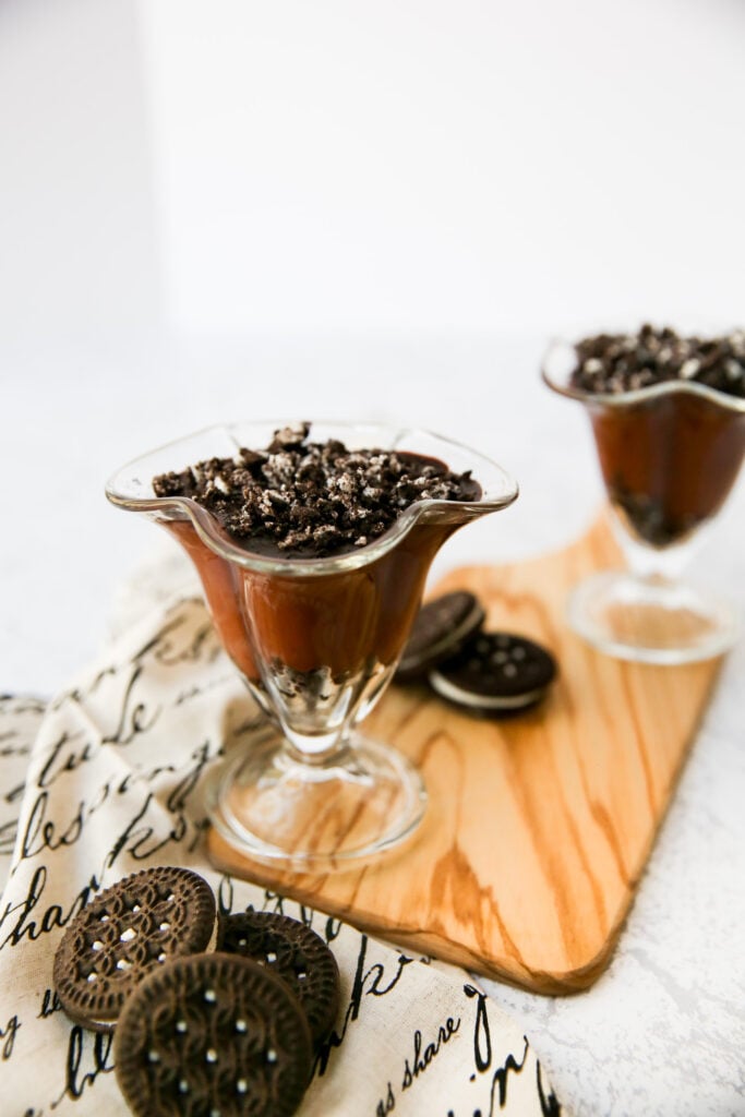 Crushed gluten-free Oreos on top of chocolate pudding.