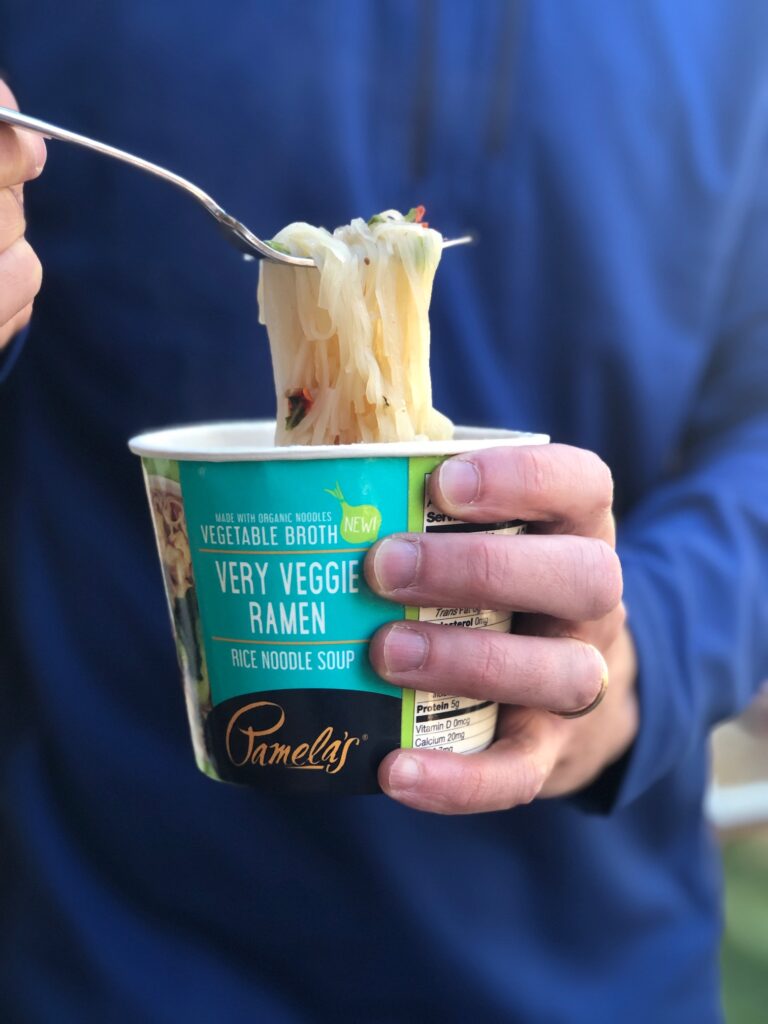 Holding a Pamela's gluten-free ramen noodle cup of soup