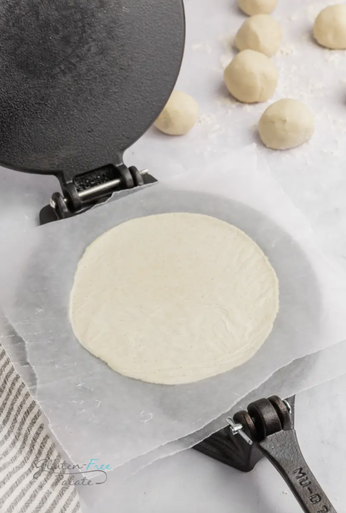 gluten-free tortillas in a press by gluten free palate
