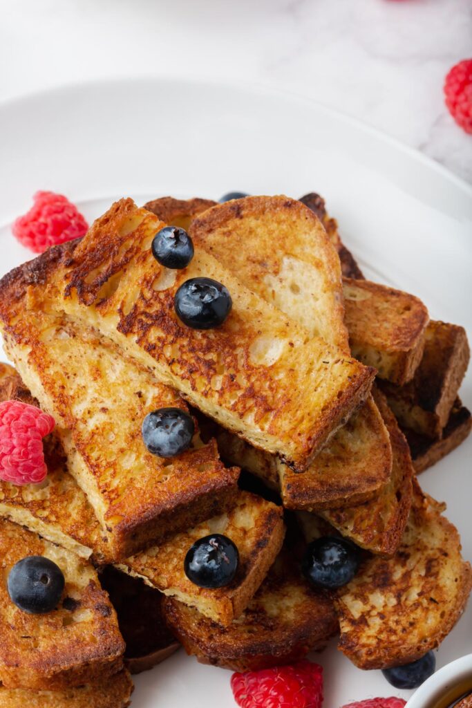 a platter with gluten-free french toast sticks and berries