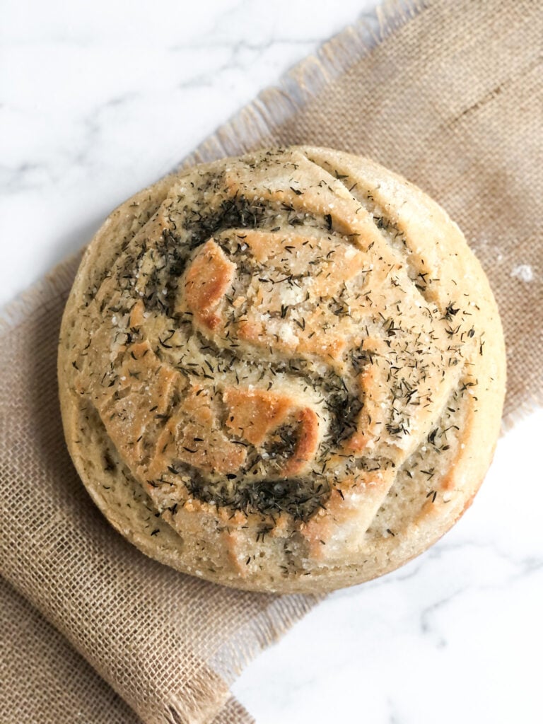 A round artisan loaf of gluten-free sourdough bread.