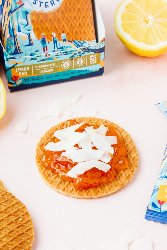 Sweet Amsterdam stroopwafel covered with jam and coconut flakes