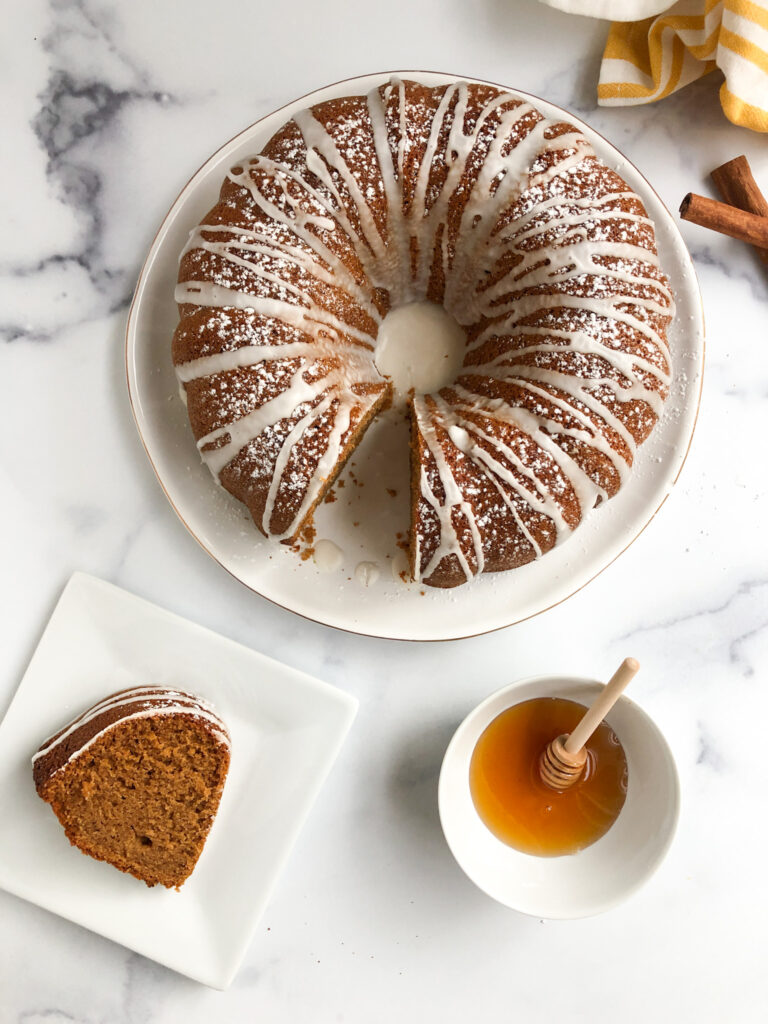 Overhead picture of gluten-free honey cake with slice of honey cake and bowl of honey