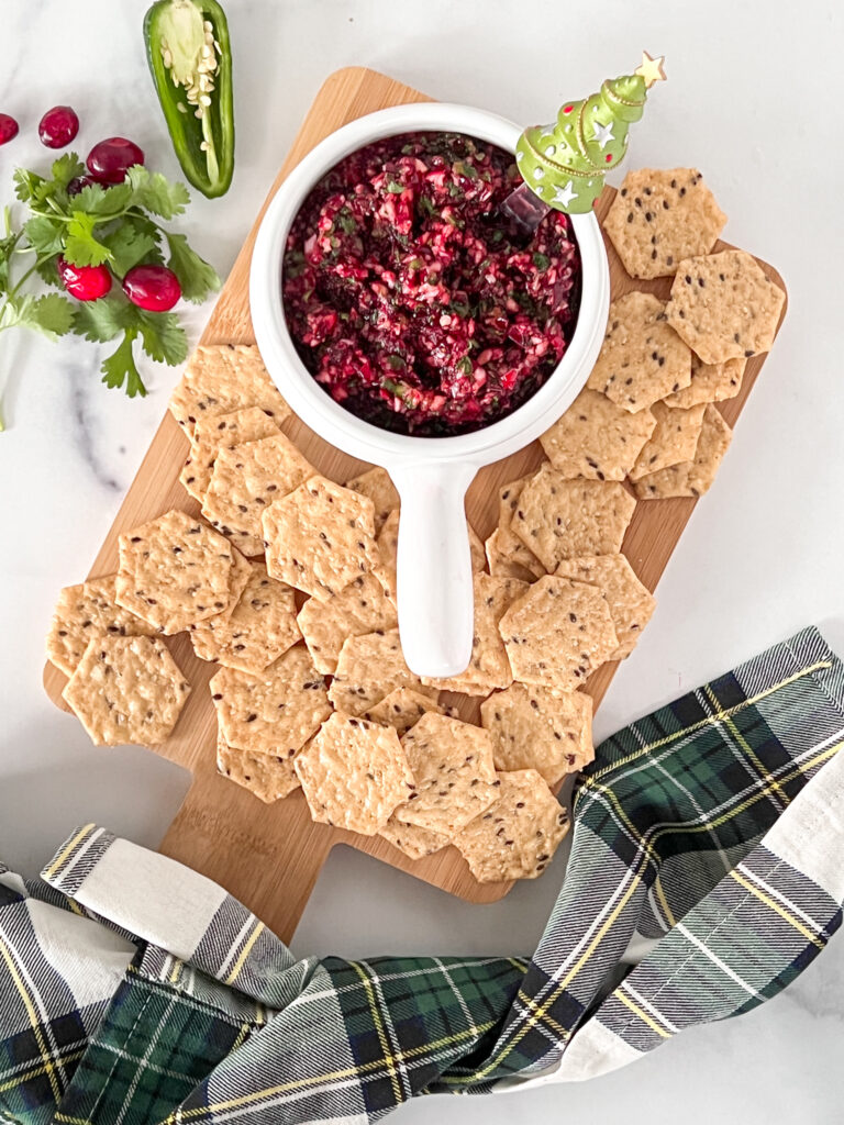 Christmas themed cranberry salsa snack board with crackers
