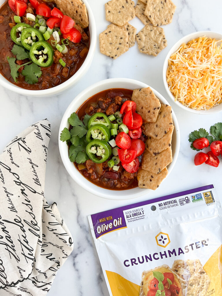 Two bowls of gluten-free chili with delicious toppings and fixings