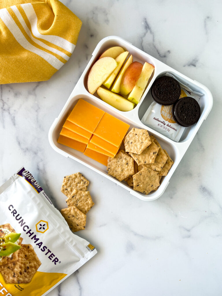 Gluten-free lunchable with crunchmaster crackers, cheese, peanut butter, apple slices and cookies