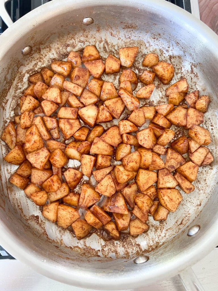 apples with spices and brandy in a pan